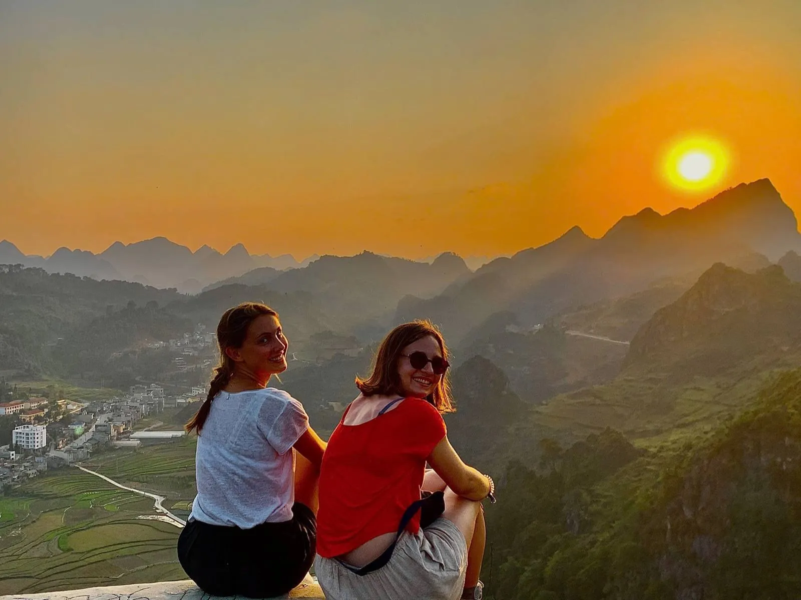 Travelers at sunset over the mountains